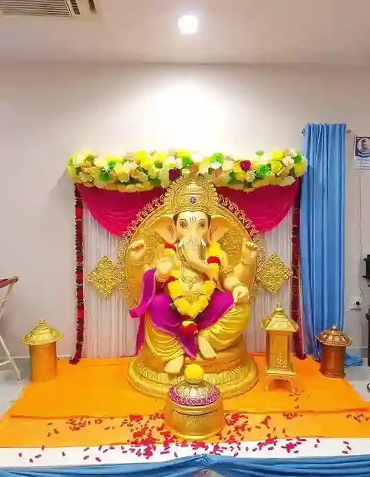 Grand Ganesh Chaturthi decoration with a large Ganpati idol and vibrant floral setup | Grand Floral Ganpati Decoration with Royal Elements | Festival Décor | Decorations Guru